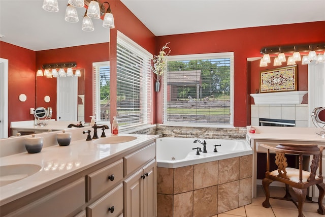 10595 Gregory Rd, Sanger, TX 76266 - full bathroom with a whirlpool tub, double vanity, tile patterned floors, and a tiled fireplace