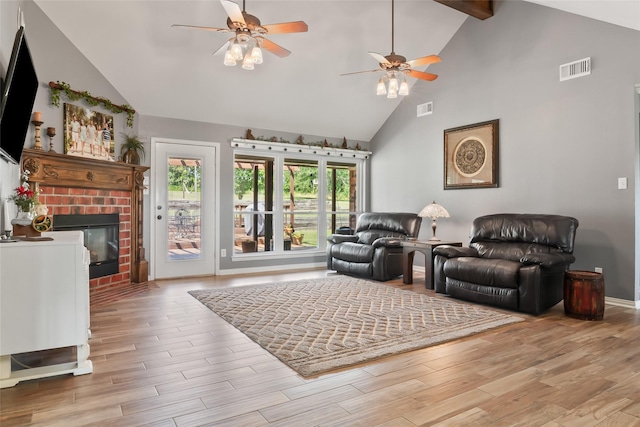 10595 Gregory Rd, Sanger, TX 76266 - living room featuring a ceiling fan, high vaulted ceiling, wood finished floors, a fireplace, and baseboards