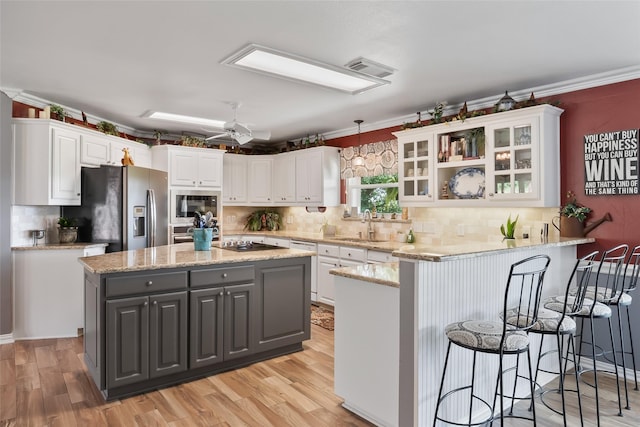 10595 Gregory Rd, Sanger, TX 76266 - kitchen with stainless steel appliances, a peninsula, white cabinetry, and crown molding