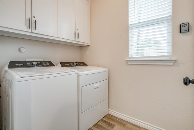 3108 Ridgecrest Dr, Granbury, TX 76048 - laundry room with independent washer and dryer, cabinet space, light wood-style flooring, and baseboards