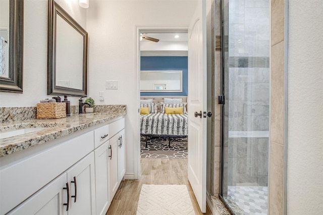 3108 Ridgecrest Dr, Granbury, TX 76048 - bathroom featuring vanity, a shower stall, wood finished floors, and ensuite bathroom