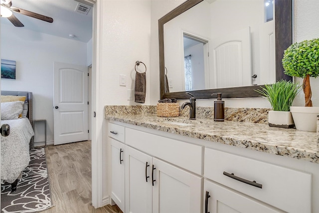 3108 Ridgecrest Dr, Granbury, TX 76048 - bathroom with vanity, a ceiling fan, wood finished floors, and baseboards