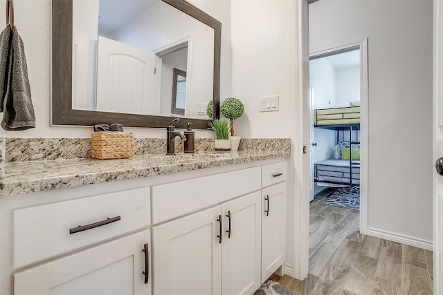 3108 Ridgecrest Dr, Granbury, TX 76048 - bathroom with vanity, wood finished floors, and baseboards