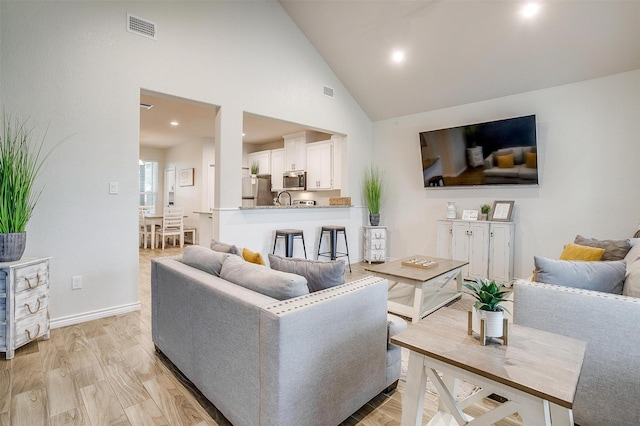3108 Ridgecrest Dr, Granbury, TX 76048 - living area featuring high vaulted ceiling, baseboards, light wood finished floors, and recessed lighting