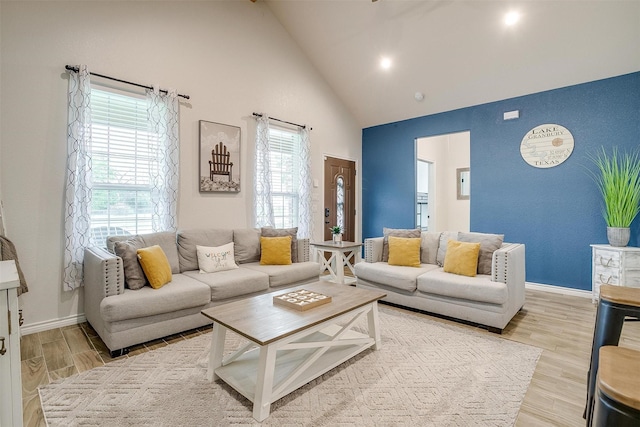 3108 Ridgecrest Dr, Granbury, TX 76048 - living area with high vaulted ceiling, plenty of natural light, wood finished floors, and baseboards