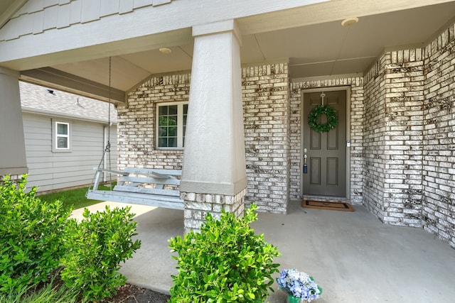 2246 Hartley Dr, Forney, TX 75126 - doorway to property featuring covered porch and brick siding