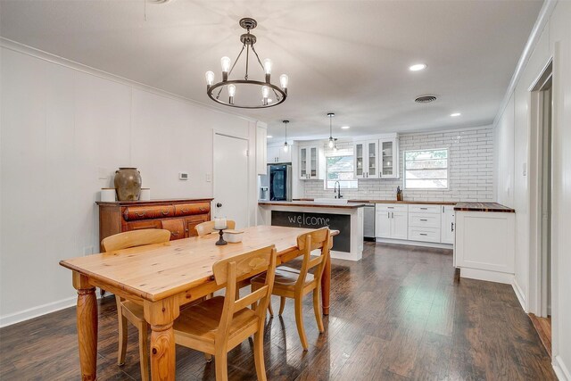 5712 Trail Lake Dr, Fort Worth, TX 76133 - dining area with a chandelier, dark wood-type flooring, ornamental molding, recessed lighting, and baseboards