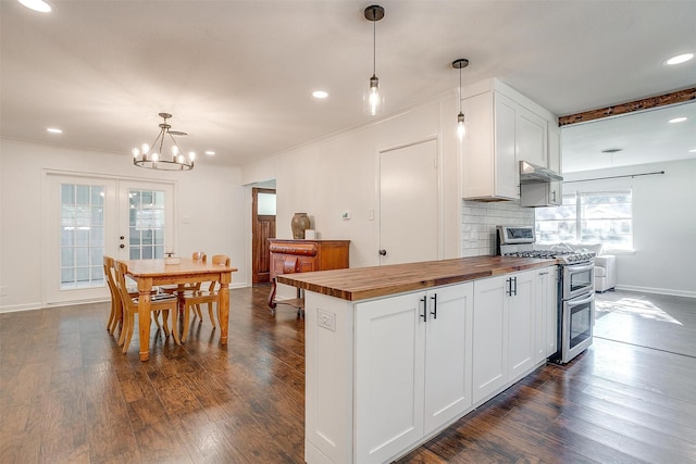 5712 Trail Lake Dr, Fort Worth, TX 76133 - kitchen with butcher block counters, double oven range, white cabinets, a chandelier, and decorative backsplash