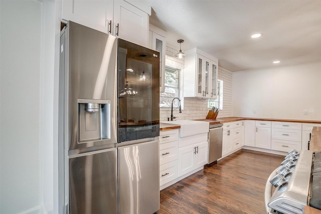 5712 Trail Lake Dr, Fort Worth, TX 76133 - kitchen with stainless steel appliances, a sink, glass insert cabinets, wooden counters, and tasteful backsplash