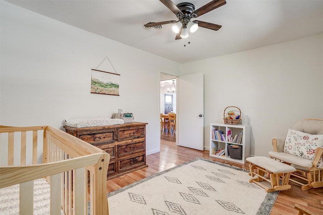 5712 Trail Lake Dr, Fort Worth, TX 76133 - bedroom with wood finished floors, a crib, and ceiling fan