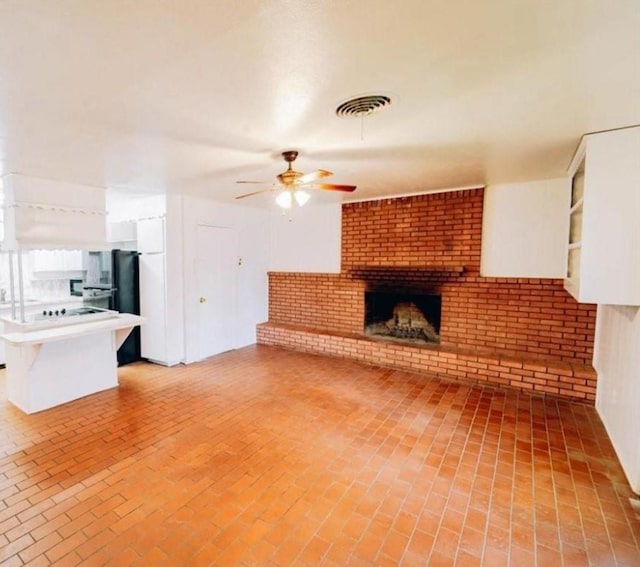 2913 Laredo Dr, Fort Worth, TX 76116 - unfurnished living room featuring ceiling fan, brick floors, and a brick fireplace
