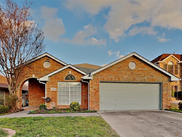 4904 Woodmeadow Dr, Fort Worth, TX 76135 - view of front of house with concrete driveway, a garage, brick siding, and a front lawn