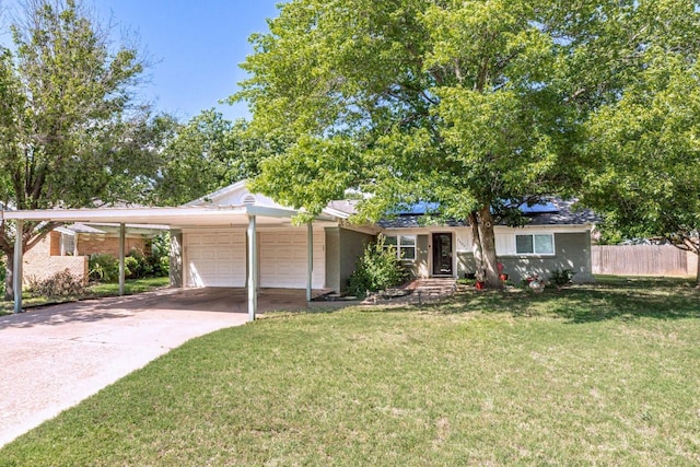 2489 Campus Ct, Abilene, TX 79601 - ranch-style house with an attached garage, driveway, solar panels, a carport, and brick siding