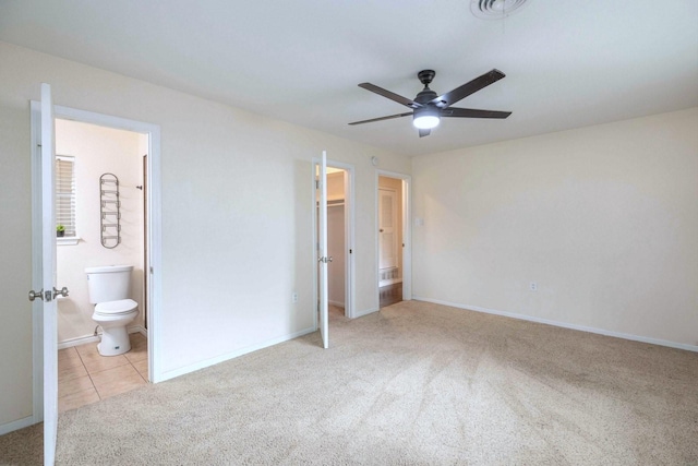 2489 Campus Ct, Abilene, TX 79601 - unfurnished bedroom featuring light carpet, baseboards, a walk in closet, and connected bathroom