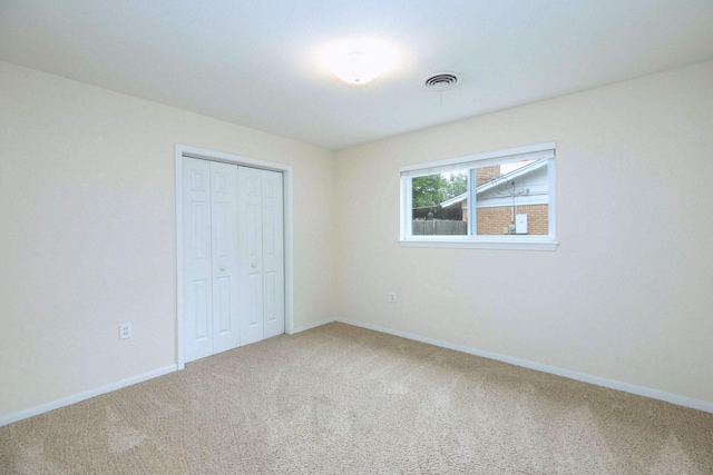 2489 Campus Ct, Abilene, TX 79601 - unfurnished bedroom featuring carpet floors, a closet, and baseboards