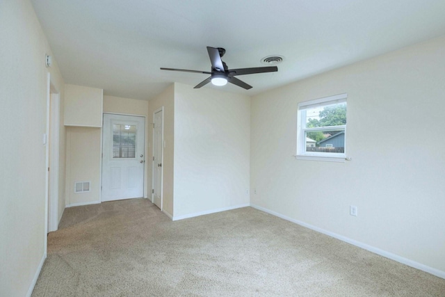 2489 Campus Ct, Abilene, TX 79601 - spare room featuring a ceiling fan, light colored carpet, and baseboards