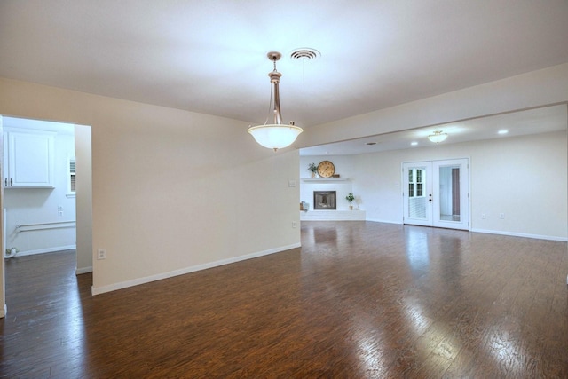 2489 Campus Ct, Abilene, TX 79601 - unfurnished living room featuring dark wood-style floors, baseboards, recessed lighting, and a glass covered fireplace