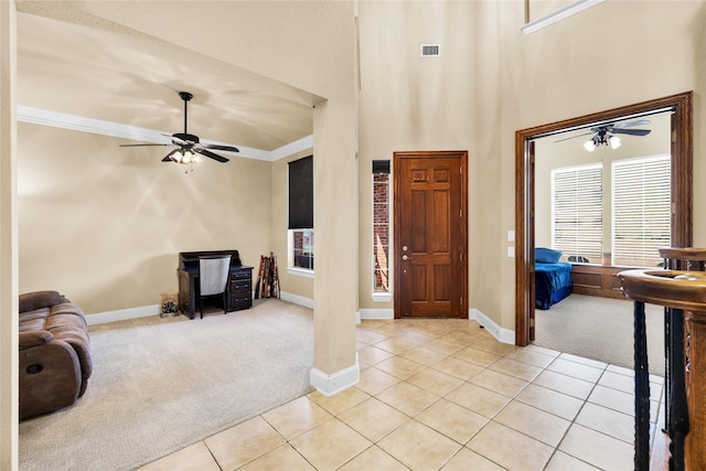 1050 Crystal Falls Dr, Prosper, TX 75078 - entrance foyer with light carpet, a ceiling fan, light tile patterned flooring, baseboards, and a high ceiling