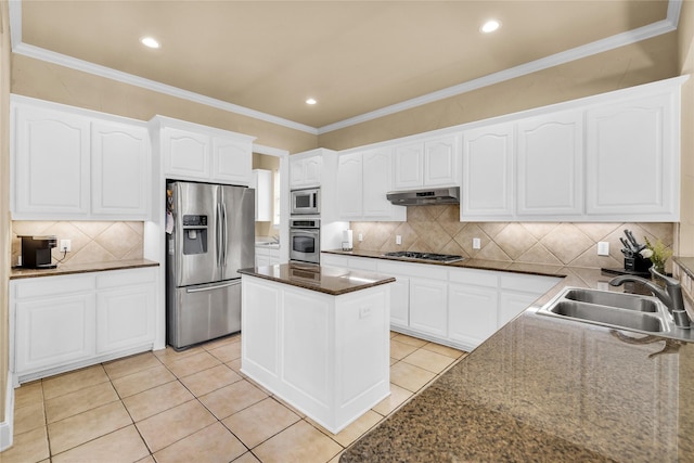 1050 Crystal Falls Dr, Prosper, TX 75078 - kitchen featuring stainless steel appliances, a sink, decorative backsplash, under cabinet range hood, and white cabinetry