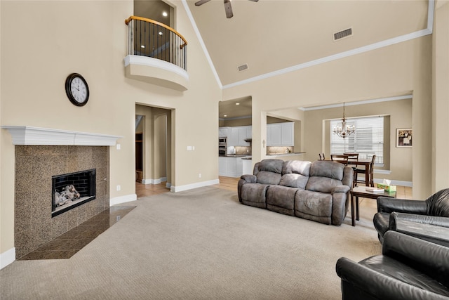 1050 Crystal Falls Dr, Prosper, TX 75078 - carpeted living room with baseboards, a towering ceiling, a ceiling fan, a chandelier, and crown molding