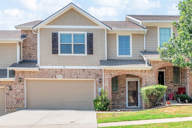 3724 Sicily St, Irving, TX 75038 - townhome / multi-family property with roof with shingles, driveway, an attached garage, and brick siding