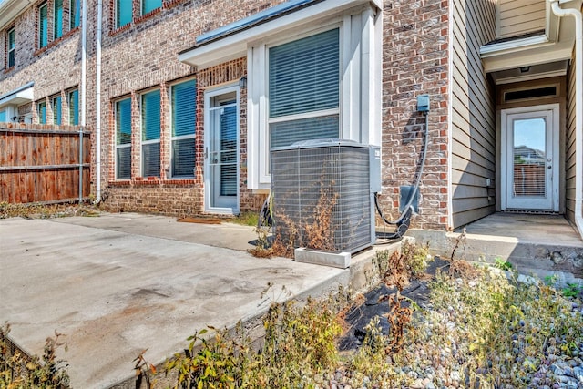 3724 Sicily St, Irving, TX 75038 - property entrance featuring central air condition unit, a patio area, and brick siding