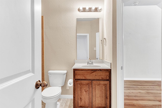 3724 Sicily St, Irving, TX 75038 - bathroom featuring vanity, toilet, baseboards, a textured wall, and wood finished floors