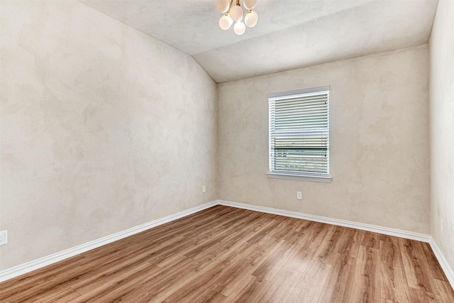 3724 Sicily St, Irving, TX 75038 - unfurnished room with wood finished floors, vaulted ceiling, baseboards, and a chandelier