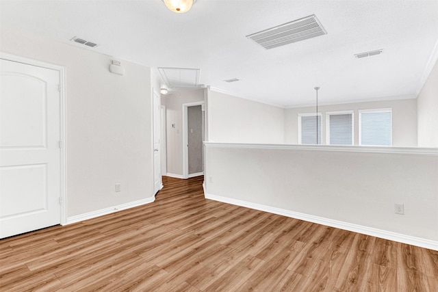 3724 Sicily St, Irving, TX 75038 - spare room featuring attic access, light wood-type flooring, baseboards, and ornamental molding