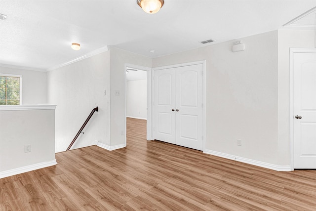 3724 Sicily St, Irving, TX 75038 - spare room with light wood-type flooring, baseboards, attic access, and crown molding