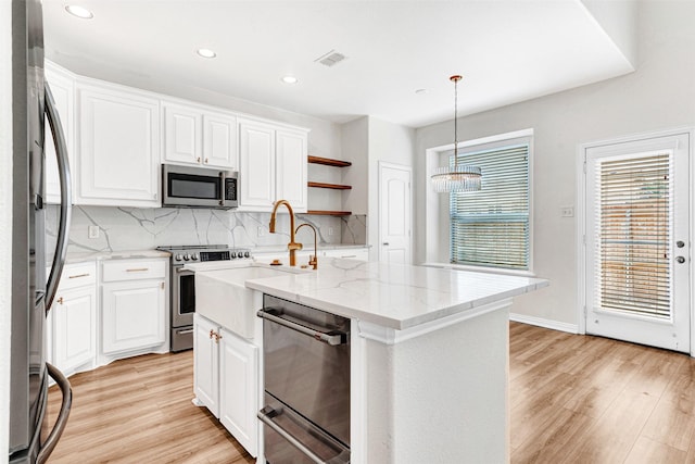 3724 Sicily St, Irving, TX 75038 - kitchen featuring appliances with stainless steel finishes, light wood-style flooring, decorative backsplash, open shelves, and white cabinets