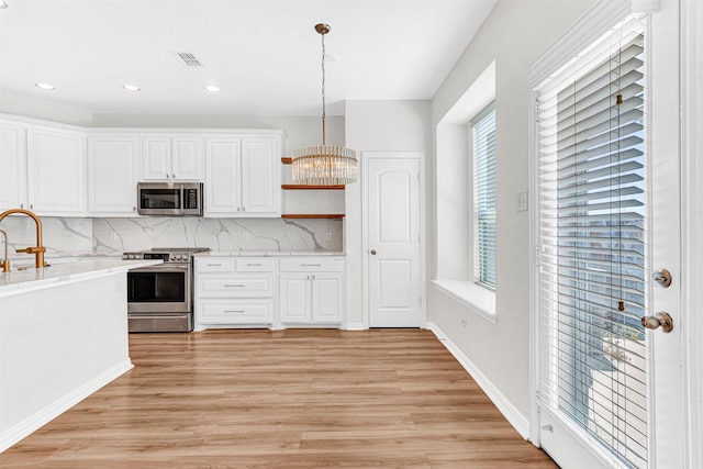 3724 Sicily St, Irving, TX 75038 - kitchen featuring stainless steel appliances, open shelves, a sink, decorative backsplash, and light wood-style flooring