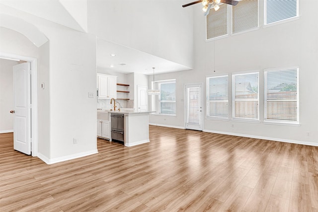 3724 Sicily St, Irving, TX 75038 - unfurnished living room with a ceiling fan, baseboards, and a high ceiling