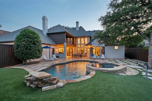5934 Shy Dr, Frisco, TX 75034 - rear view of property featuring a patio, a shingled roof, a pool with connected hot tub, and a balcony