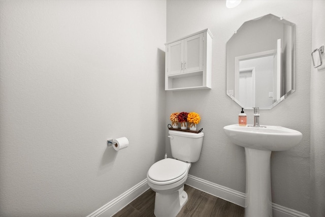 3604 Hidden Hollow Dr, Grand Prairie, TX 76065 - bathroom featuring toilet, wood finished floors, and baseboards