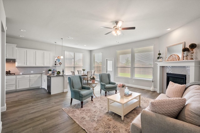 3604 Hidden Hollow Dr, Grand Prairie, TX 76065 - living area featuring a ceiling fan, dark wood-style floors, baseboards, recessed lighting, and a fireplace
