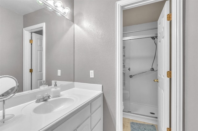 1125 Starling Ct, Burleson, TX 76028 - full bath with vanity, walk in shower, a textured wall, and toilet