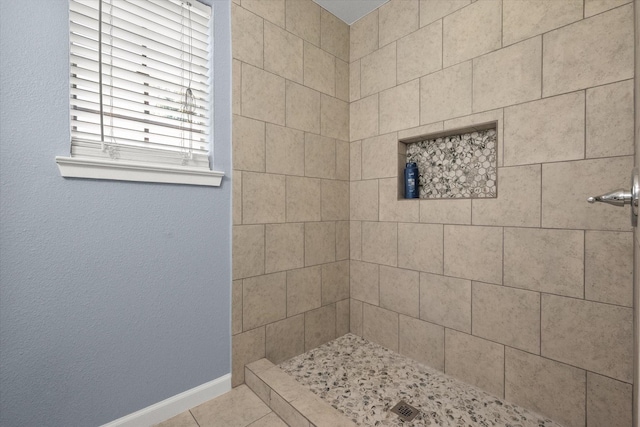 209 Circle Dr, Alvarado, TX 76009 - bathroom featuring a tile shower, baseboards, and tile patterned flooring