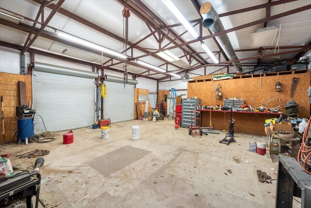 209 Circle Dr, Alvarado, TX 76009 - garage featuring a workshop area and a garage door opener