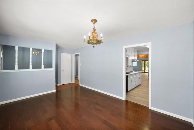 209 Circle Dr, Alvarado, TX 76009 - unfurnished room featuring a chandelier, wood finished floors, and baseboards