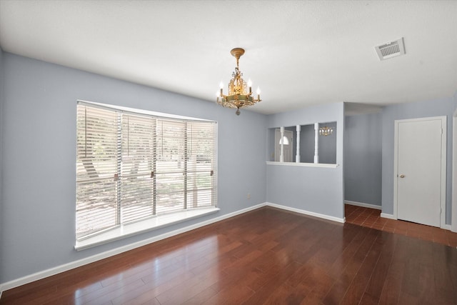 209 Circle Dr, Alvarado, TX 76009 - unfurnished room with a chandelier, baseboards, and wood finished floors