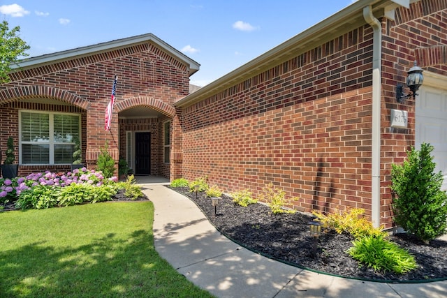 6173 Arcadia Park Ln, Frisco, TX 75036 - property entrance with brick siding, a yard, and an attached garage
