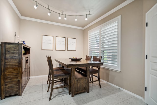 6173 Arcadia Park Ln, Frisco, TX 75036 - dining area featuring crown molding, light tile patterned flooring, baseboards, and rail lighting