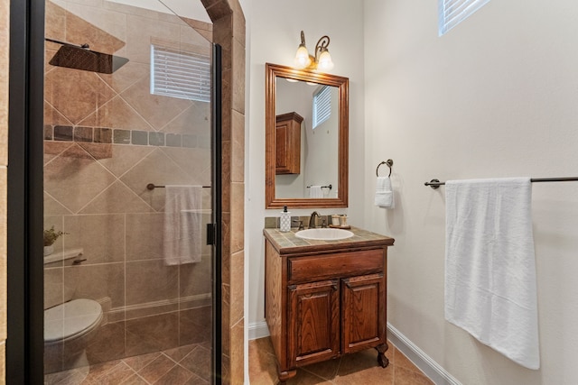 4452 Druid Hills Dr, Frisco, TX 75034 - bathroom with a stall shower, vanity, tile patterned floors, toilet, and baseboards
