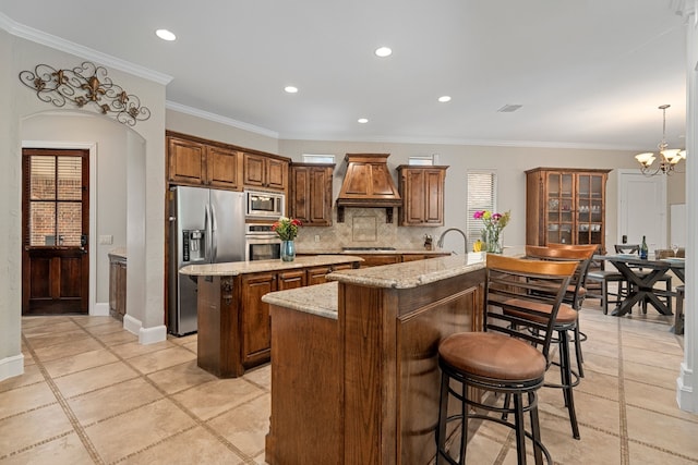 4452 Druid Hills Dr, Frisco, TX 75034 - kitchen featuring stainless steel appliances, a center island with sink, custom range hood, backsplash, and a chandelier