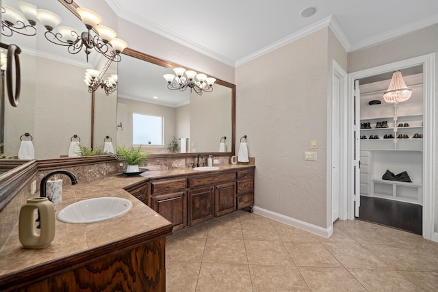 4452 Druid Hills Dr, Frisco, TX 75034 - bathroom with double vanity, a textured wall, a chandelier, tile patterned floors, and ornamental molding