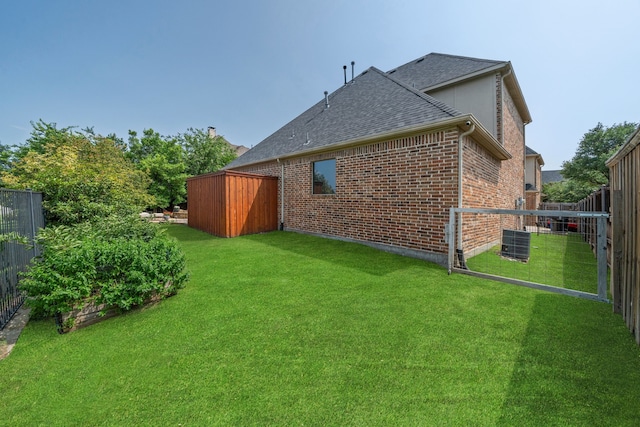 4452 Druid Hills Dr, Frisco, TX 75034 - back of property with central air condition unit, brick siding, and a shingled roof