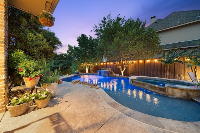 4452 Druid Hills Dr, Frisco, TX 75034 - pool at dusk with a fenced backyard, a pool with connected hot tub, and a patio area
