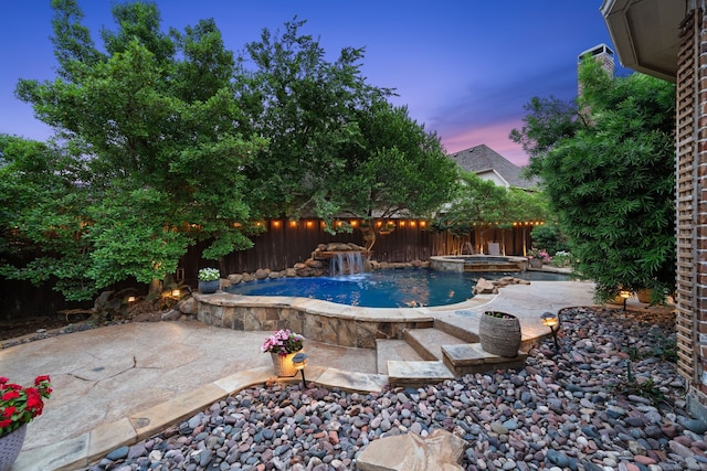4452 Druid Hills Dr, Frisco, TX 75034 - pool at dusk with a fenced backyard, a patio area, and a pool with connected hot tub