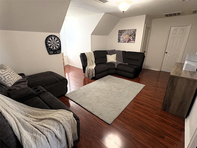 702 John Thomas Dr, Keene, TX 76059 - living room featuring dark wood-type flooring, vaulted ceiling, and baseboards
